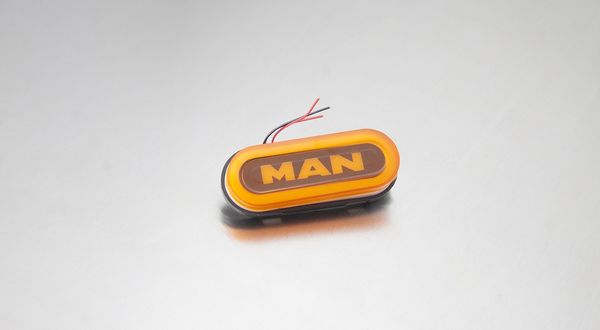 Ліхтар габаритний овал НЕОН напис "MAN" жовтий MG101594 фото